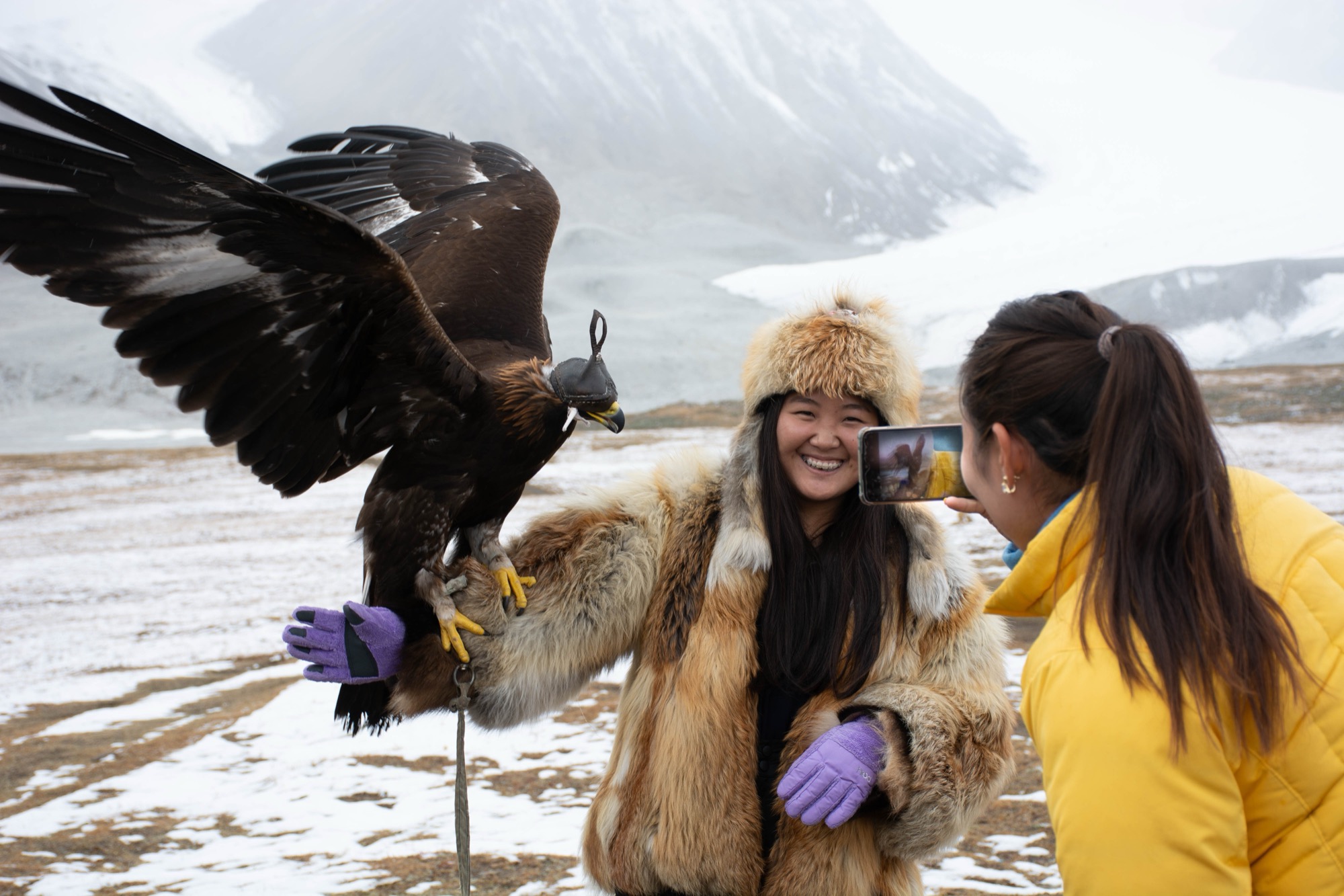 Travelers using a smartphone in the remote Altai Tavan Bogd mountains of western Mongolia